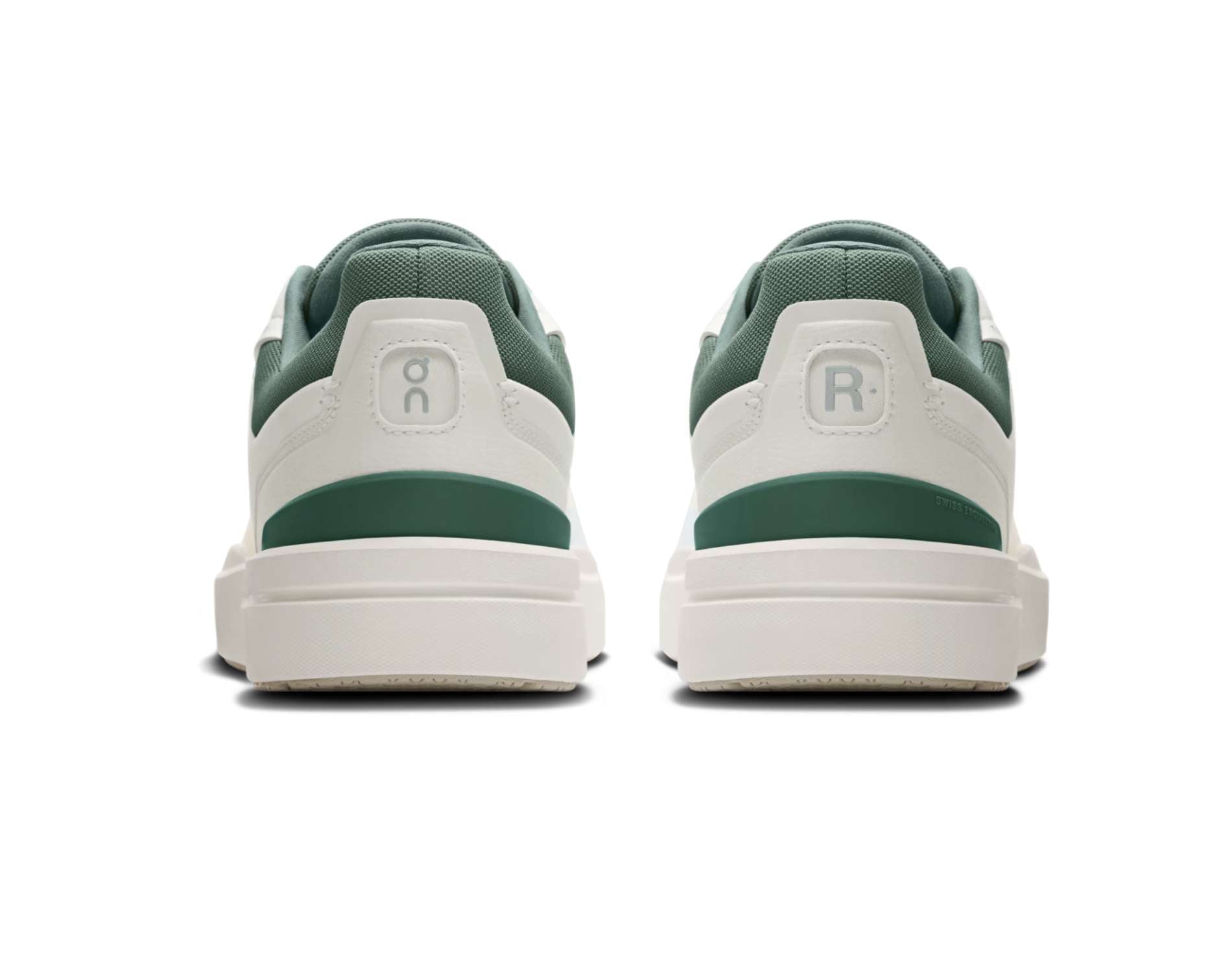 Green and white sneakers with brand logos on a white background