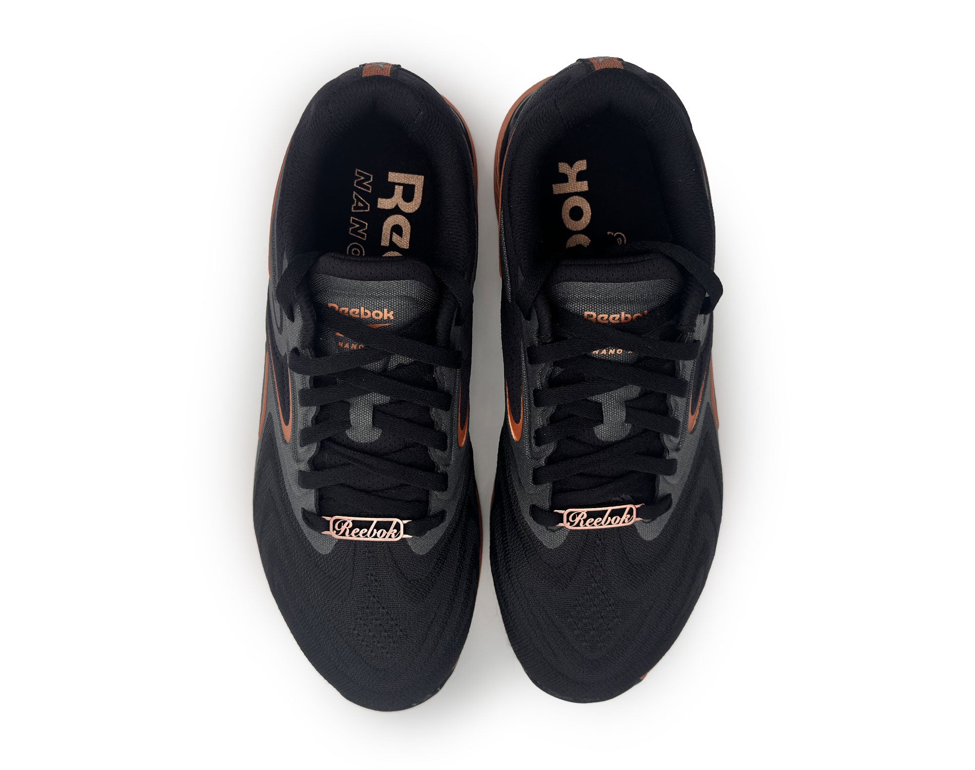 Black Reebok running shoes with copper accents on a white background