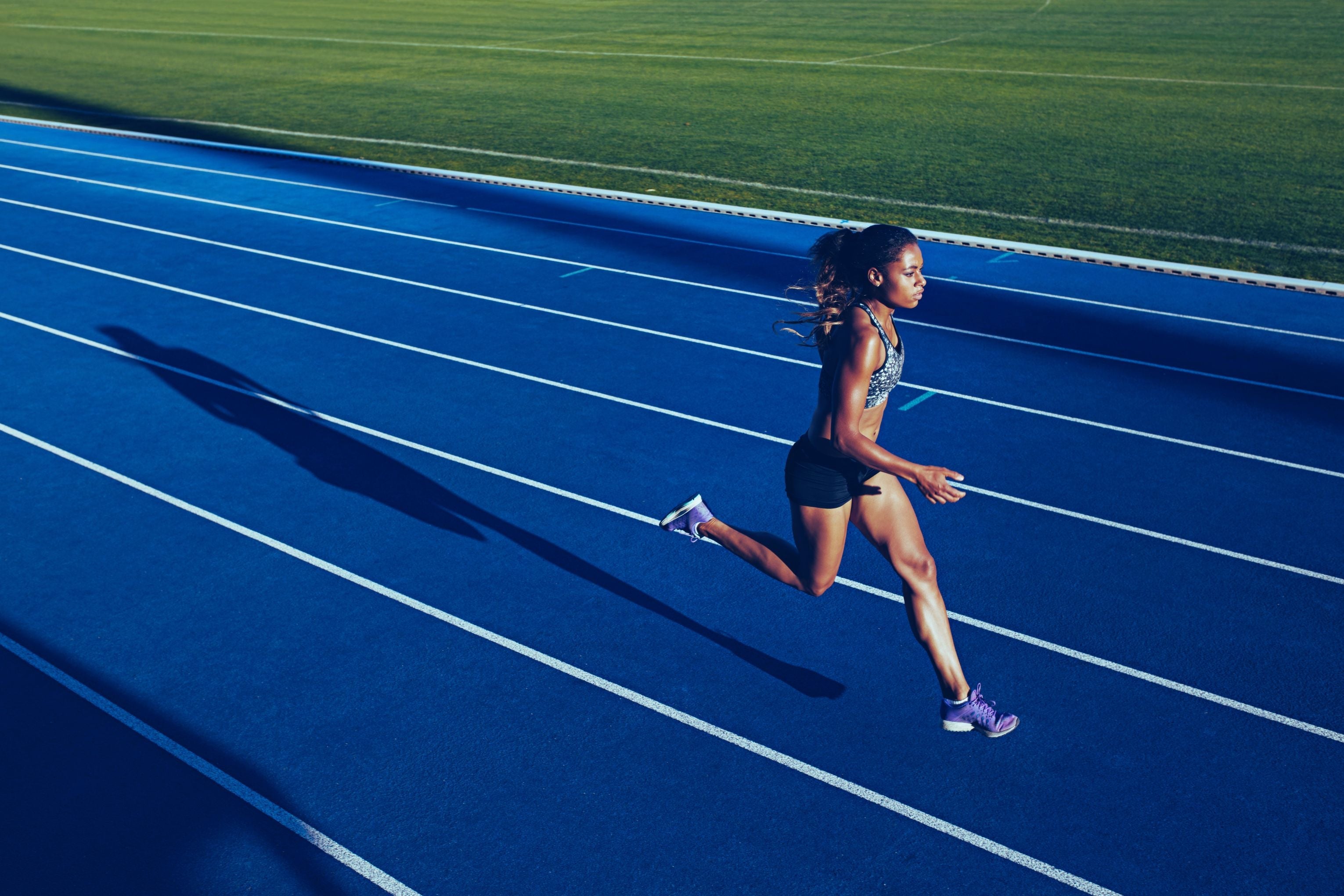 A woman running on a racetrack