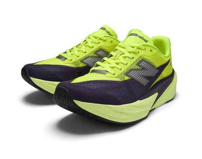 Pair of neon green and black running shoes on a white background