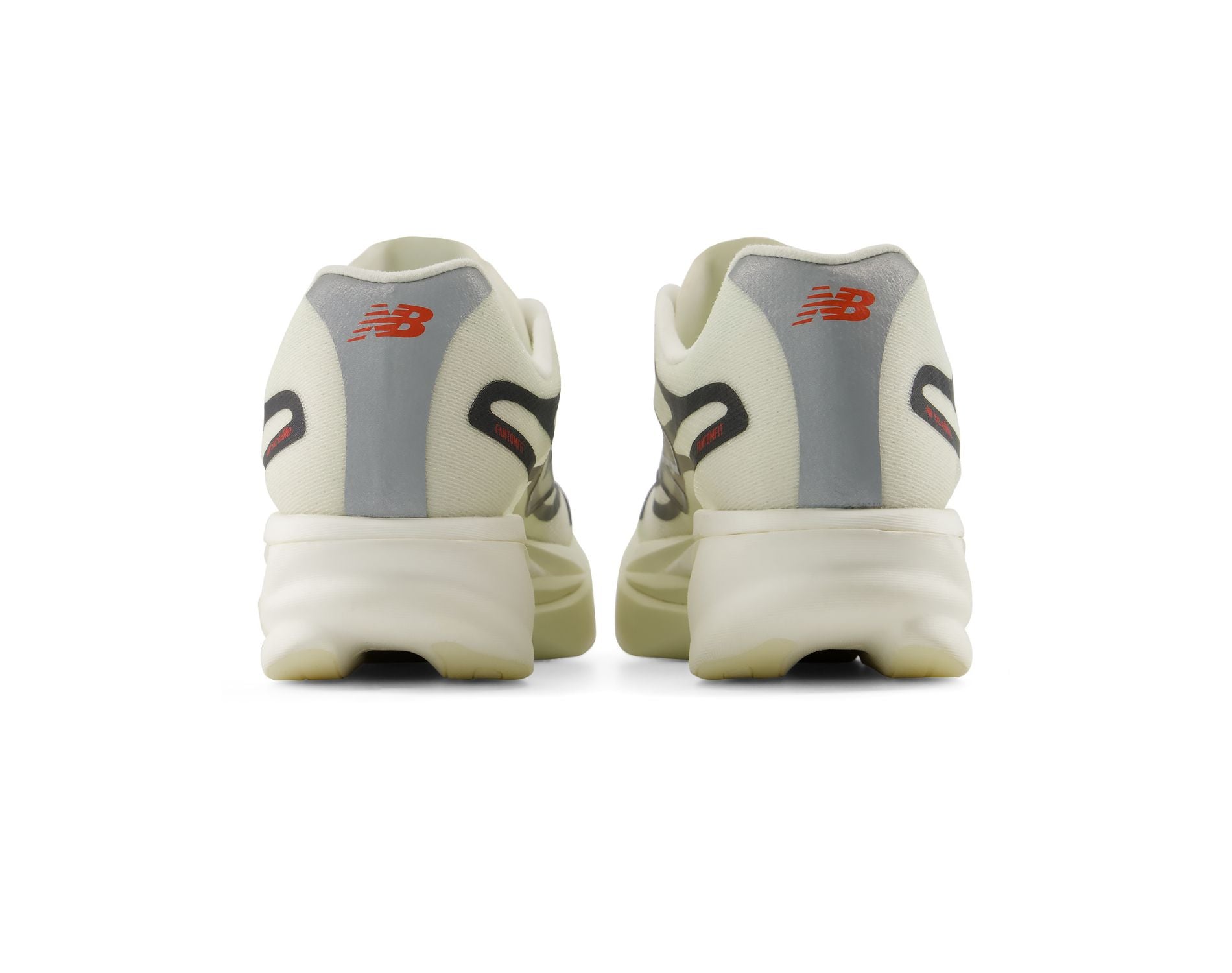 A pair of New Balance sneakers shown from the back, featuring off-white and gray uppers with red 'NB' logos and black side accents, set against a plain white background.