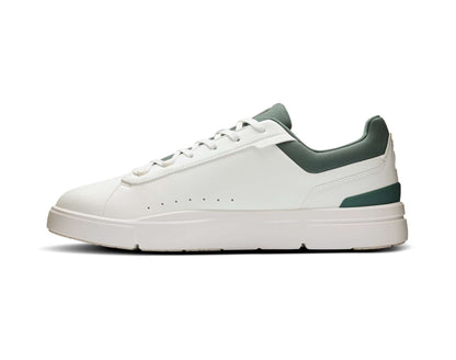 White sneaker with green accents on a white background