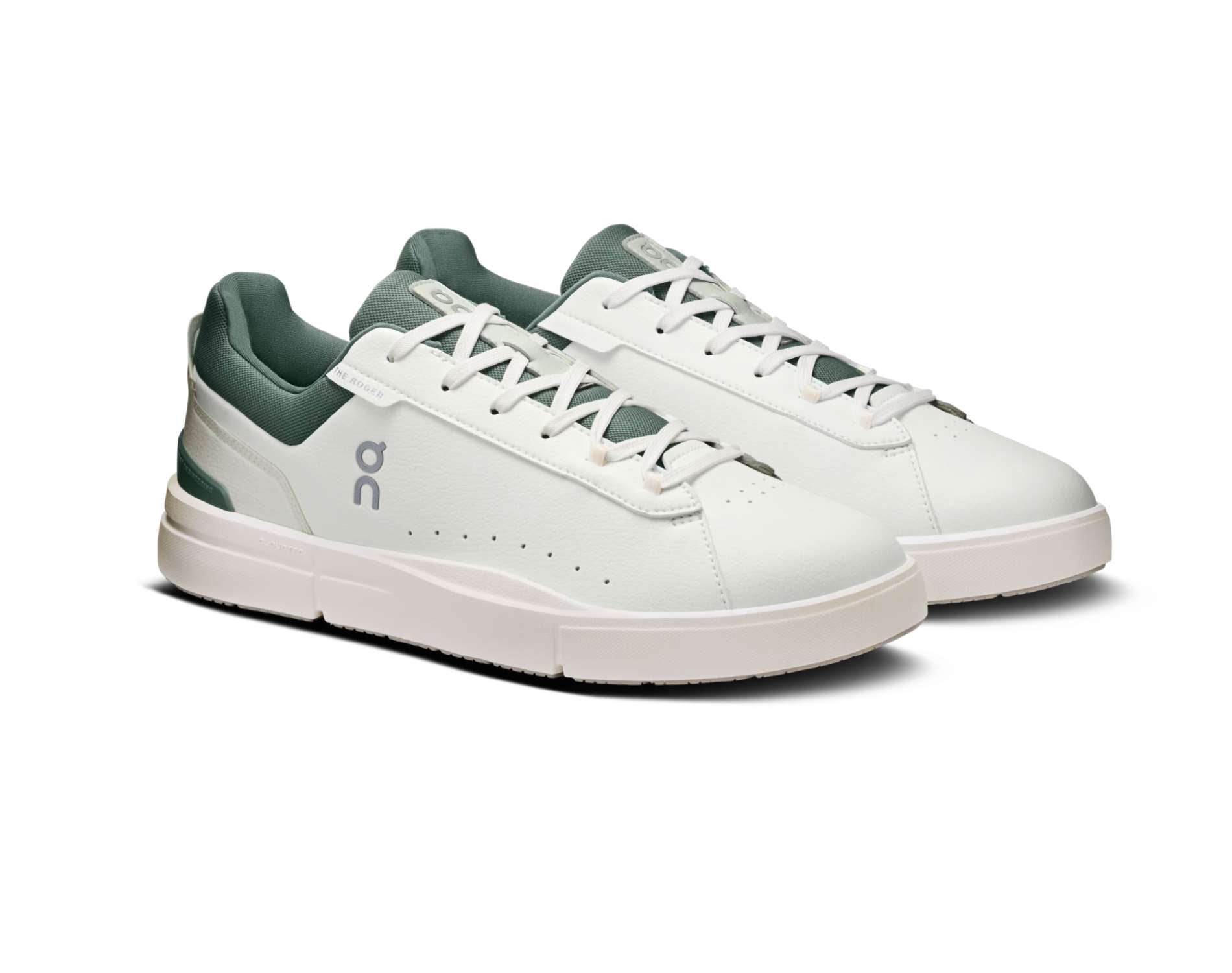 White sneakers with green accents on a white background
