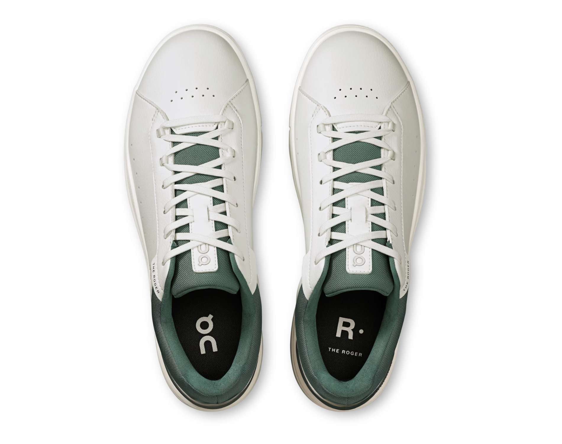 White sneakers with green accents on a white background