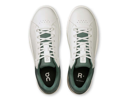 White sneakers with green accents on a white background